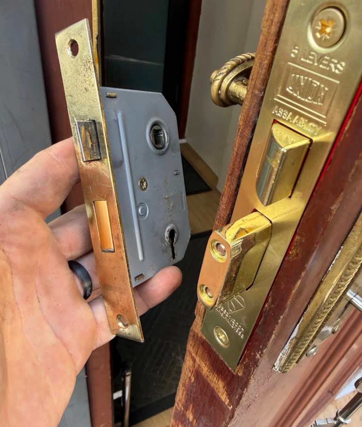 Photo of a replacement lock case being fitted into a wooden door